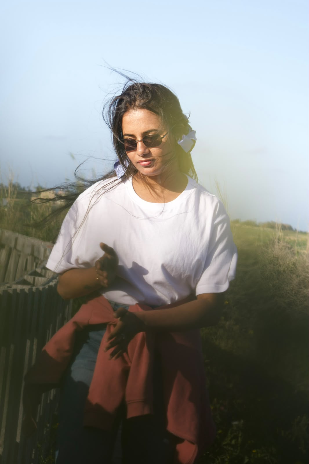 Golden hour portrait in a windswept field