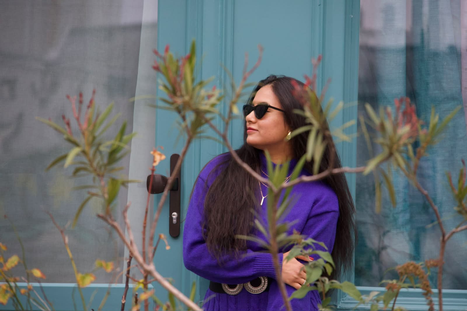 Portrait in violet against a teal Parisian door