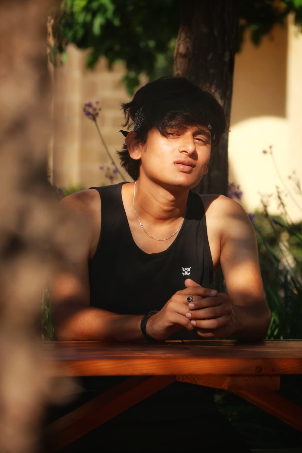 Golden hour portrait under a tree, black tank