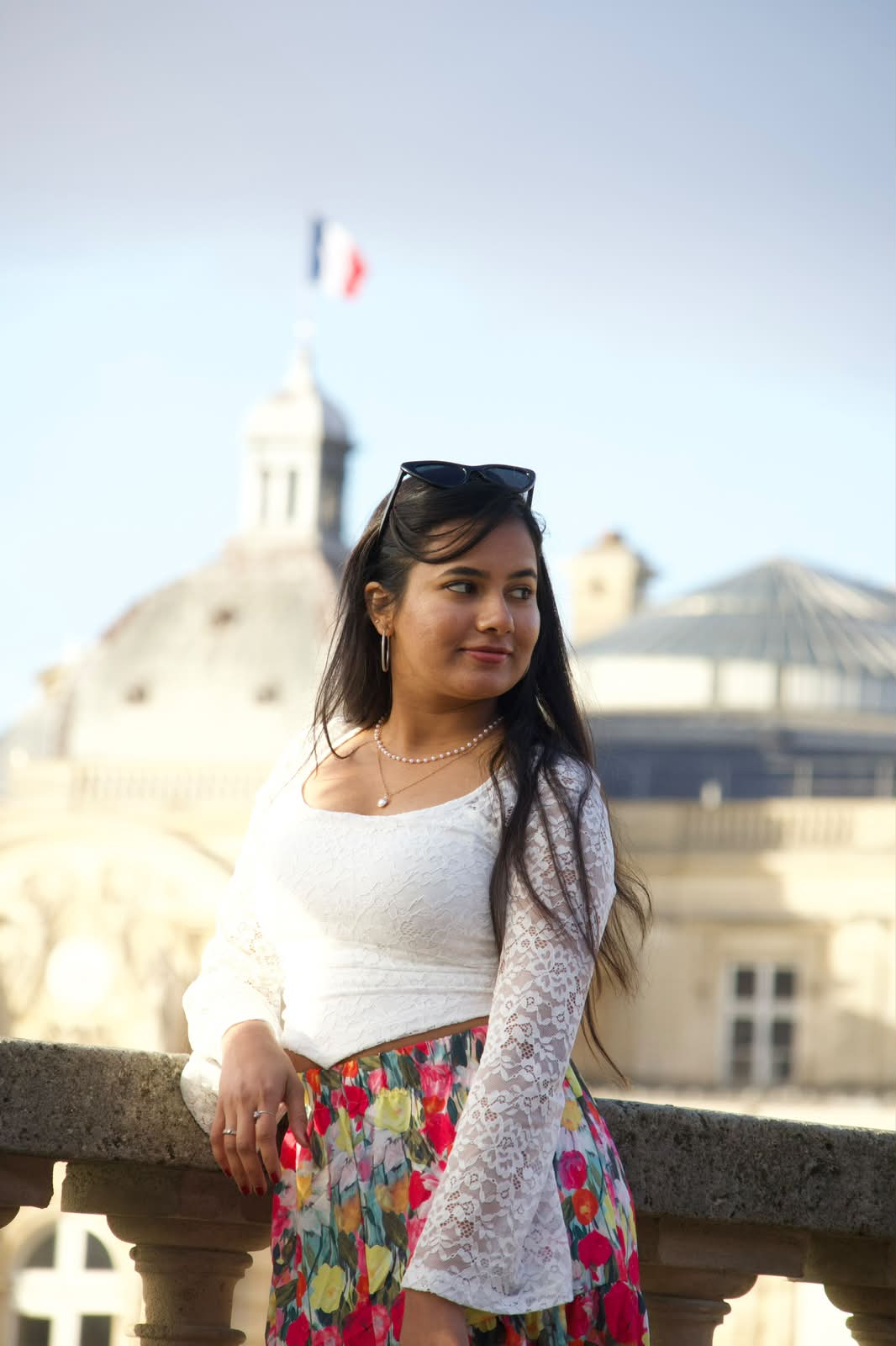 Portrait on a Paris balcony beneath the tricolore