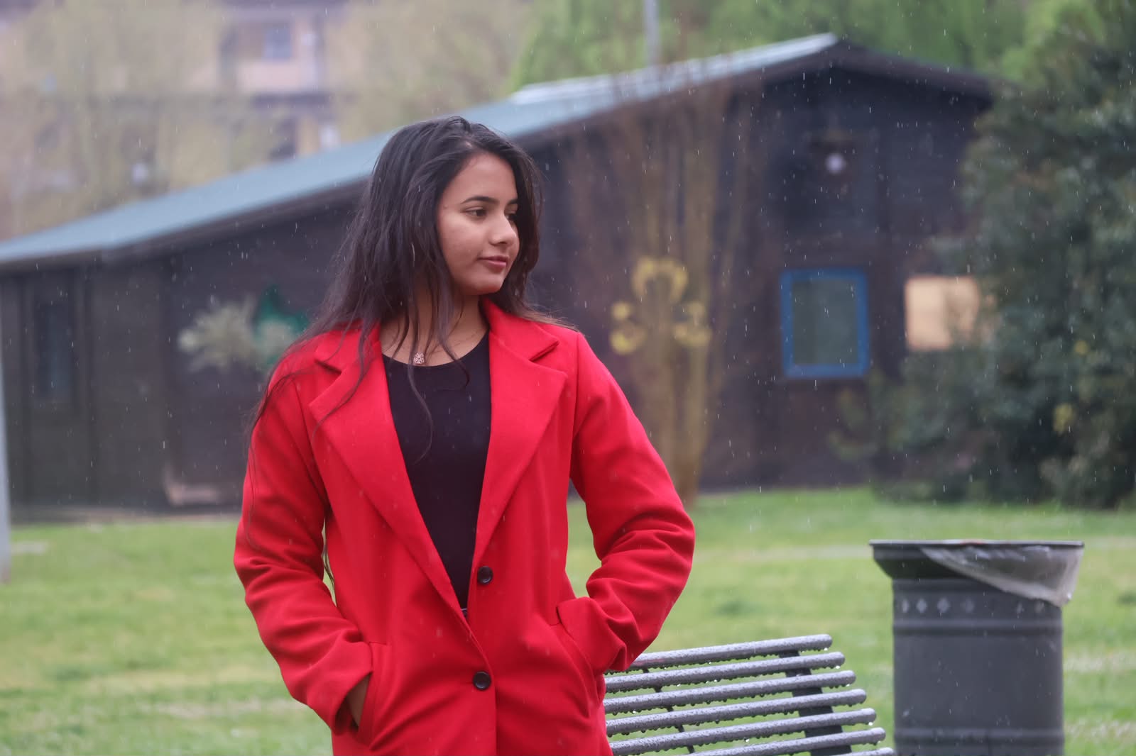 Portrait in red coat, rainy afternoon