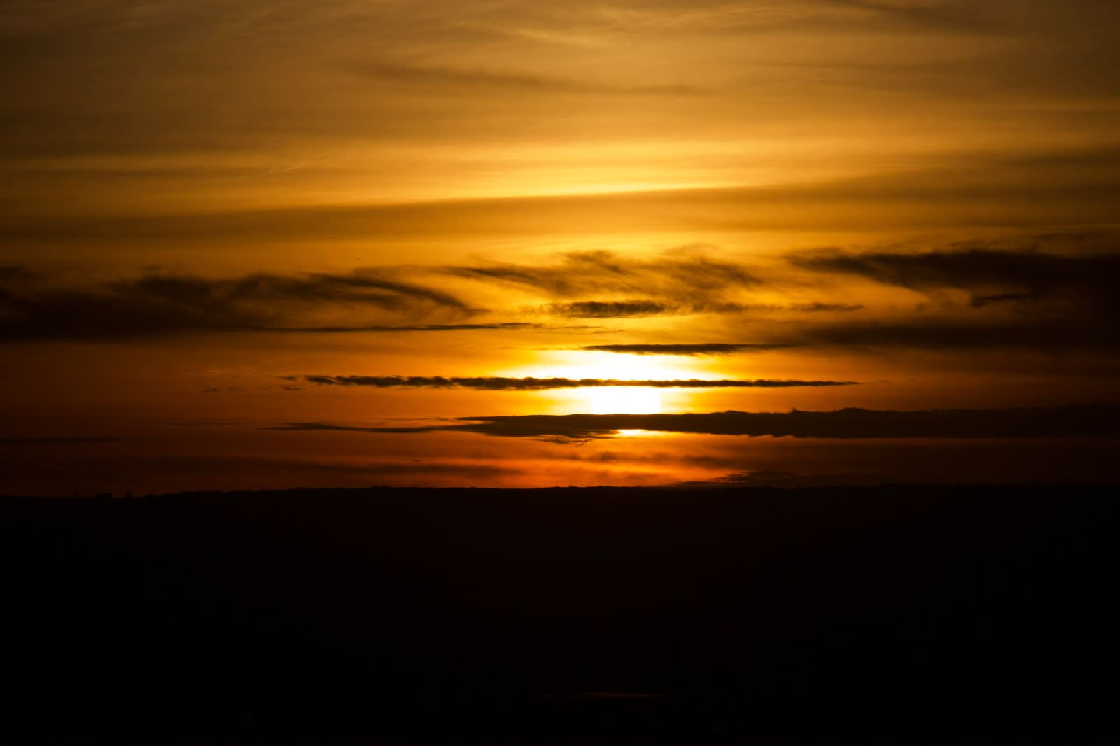 Burning sunset above the horizon