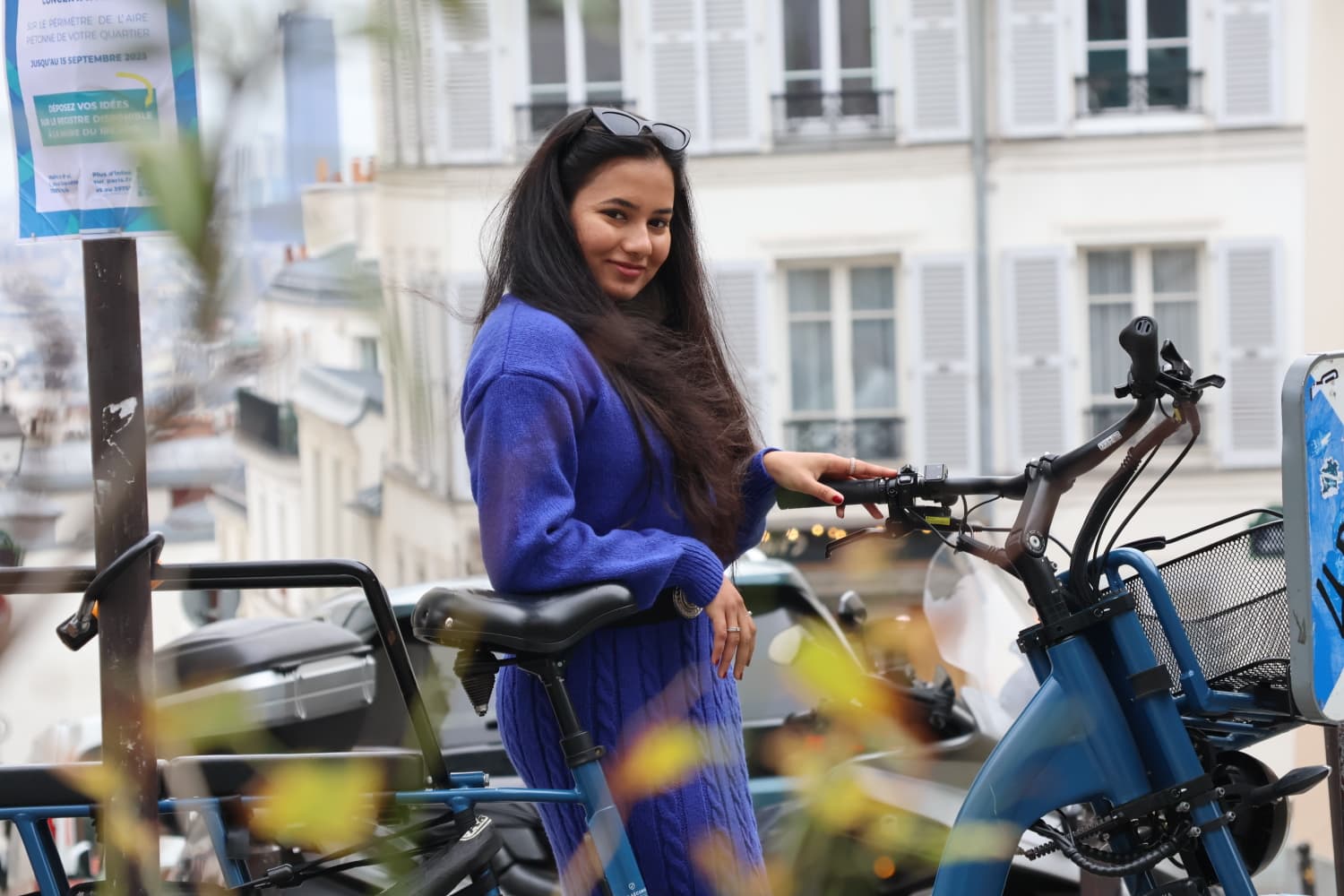 Portrait in blue beside a Parisian bike stand