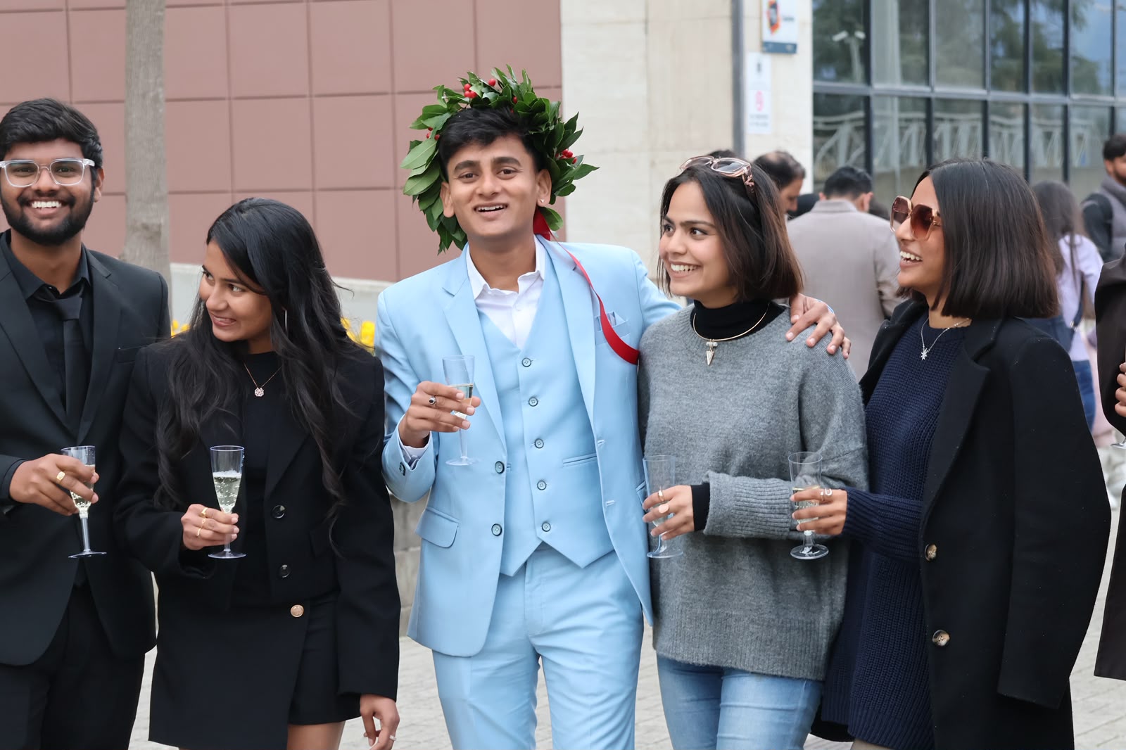 Graduation celebration with friends and laurel wreath