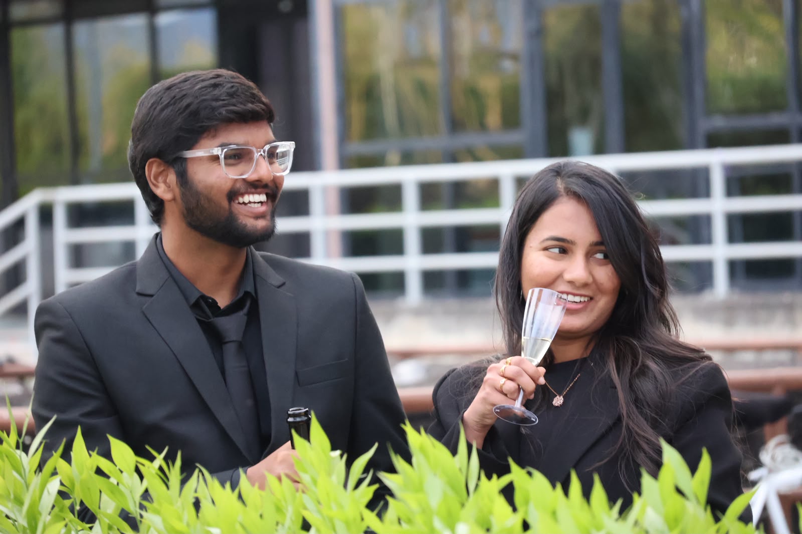 Candid toast between two friends in formal wear