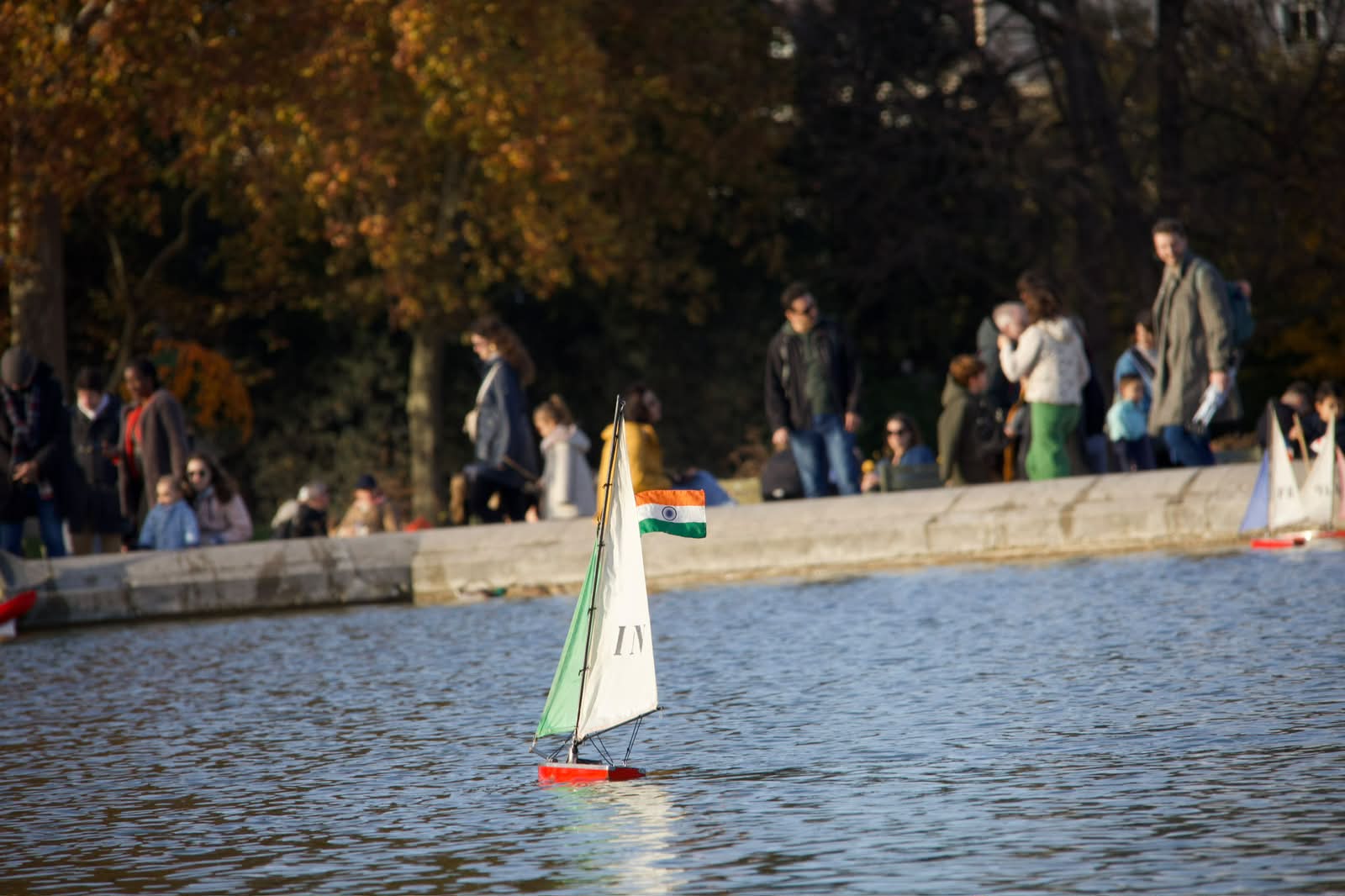 Toy sailboat with Indian flag drifting in Paris