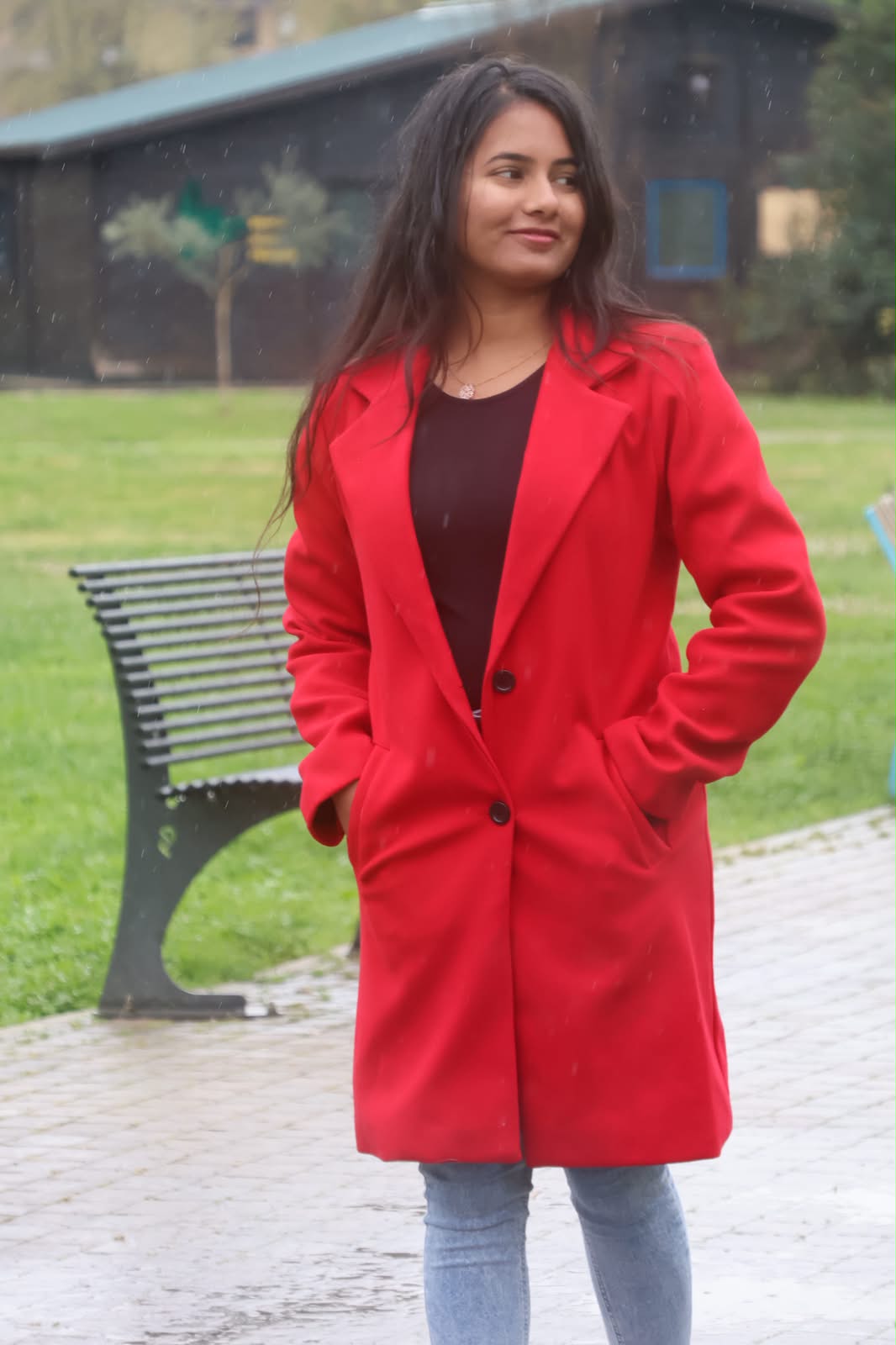 Full-length portrait in red coat at the park